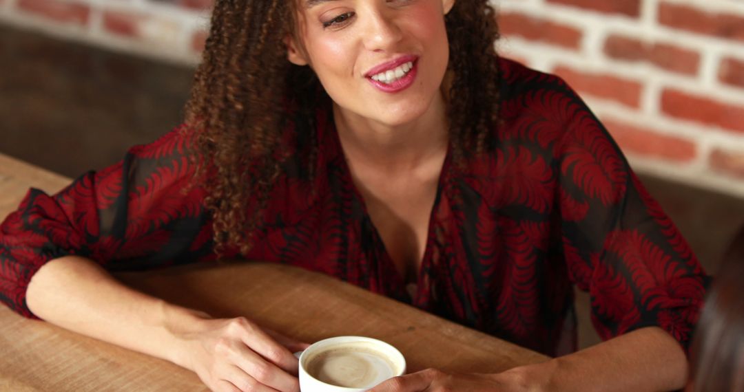 Smiling Woman with Cup of Coffee at Cozy Café Table - Free Images, Stock Photos and Pictures on Pikwizard.com