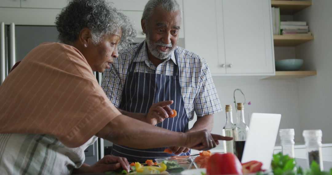 Happy african american senior couple cooking and talking together - Free Images, Stock Photos and Pictures on Pikwizard.com