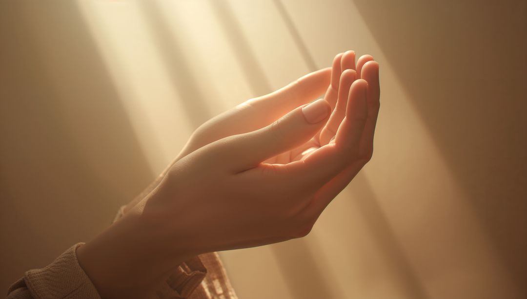 Sunlit cupped hands receiving warm morning sunlight through window rays, serene close-up