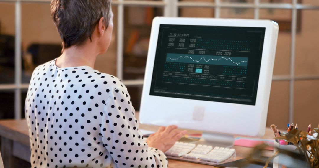 Senior Professional Analyzing Financial Data on Desktop Monitor - Free Images, Stock Photos and Pictures on Pikwizard.com