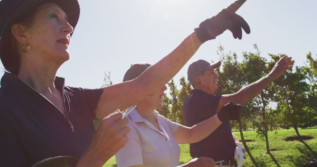 Seniors Enjoying Golf on Sunny Day Pointing in the Direction