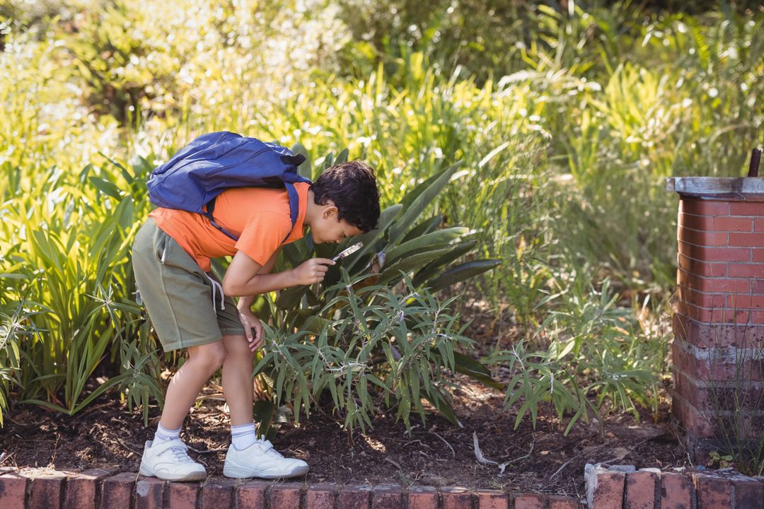 Child Exploring Nature in Garden With Magnifying Glass