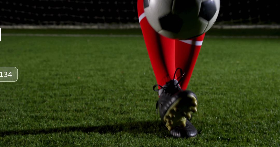 Soccer Player Balancing Ball on Turf at Night