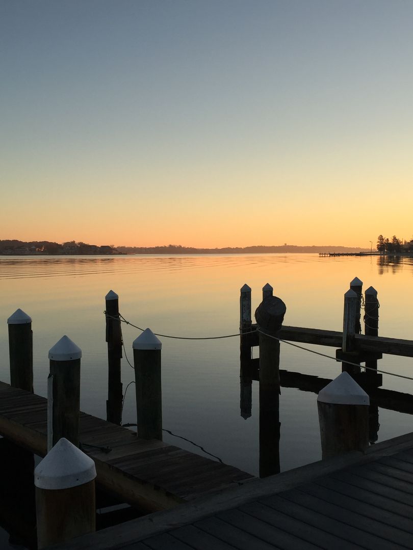 Tranquil Sunrise Over Calm Lake with Wooden Dock - Free Images, Stock Photos and Pictures on Pikwizard.com