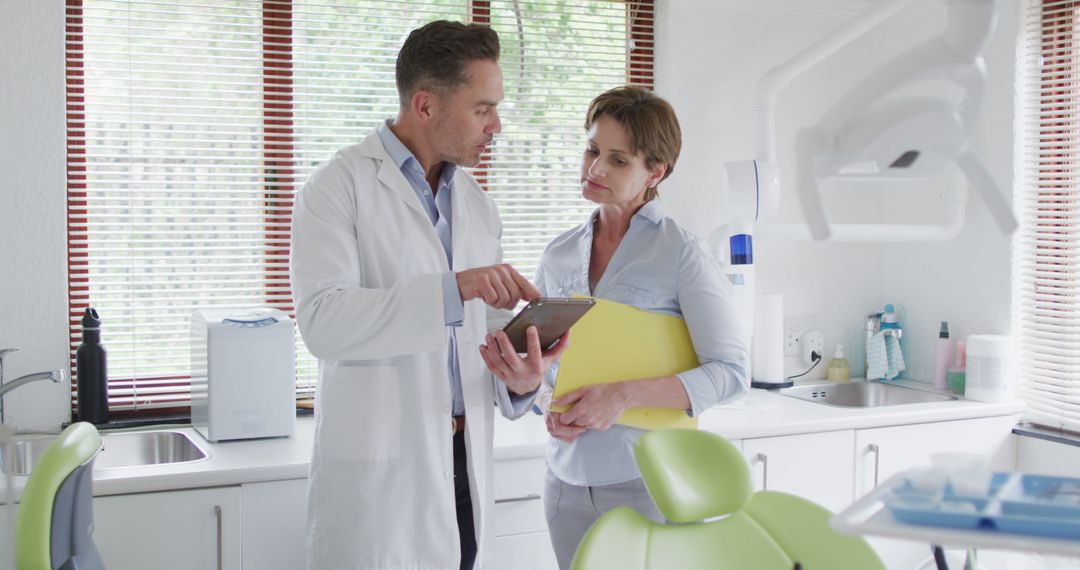 Dentist Discussing Treatment Plan with Patient in Modern Clinic - Free Images, Stock Photos and Pictures on Pikwizard.com