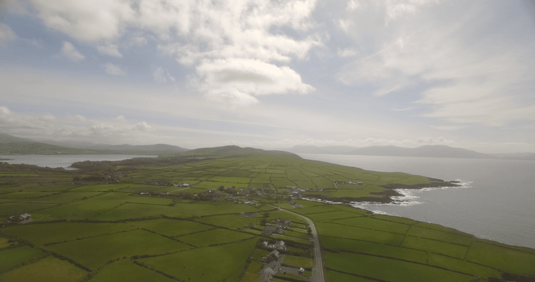 Breathtaking Transparent Fields by the Coast under Cloudy Sky