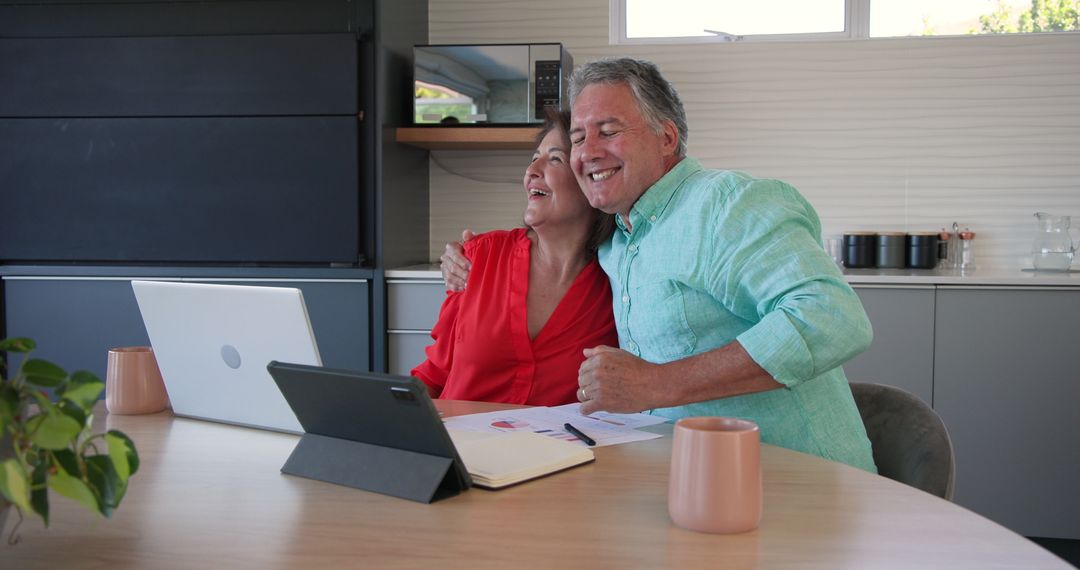Joyful Senior Couple Embracing Technology During Refreshing Home Moment