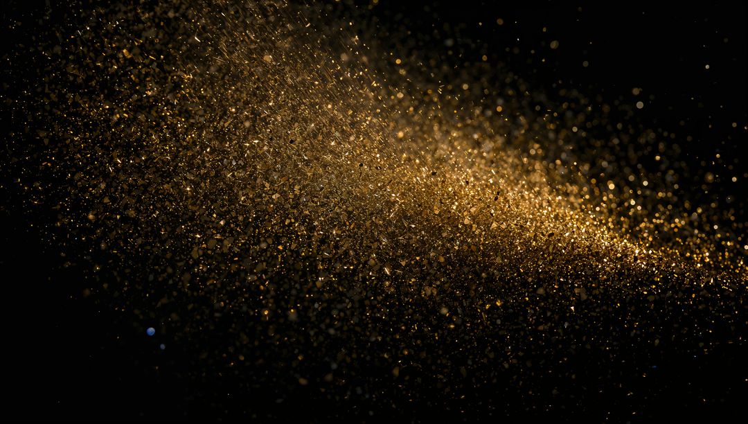 Shimmering Gold Dust Cloud Sweeping Across Black Background with Diagonal Sparkle Trail