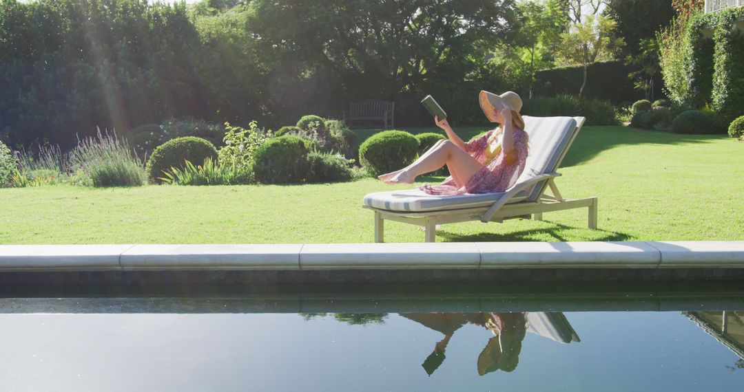 Woman Relaxing on Lounger by Pool in Sunlit Garden - Free Images, Stock Photos and Pictures on Pikwizard.com