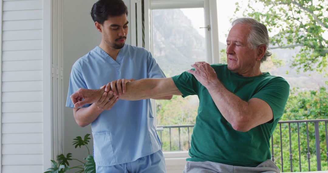 Physiotherapist Assisting Elderly Man with Arm Exercises - Free Images, Stock Photos and Pictures on Pikwizard.com