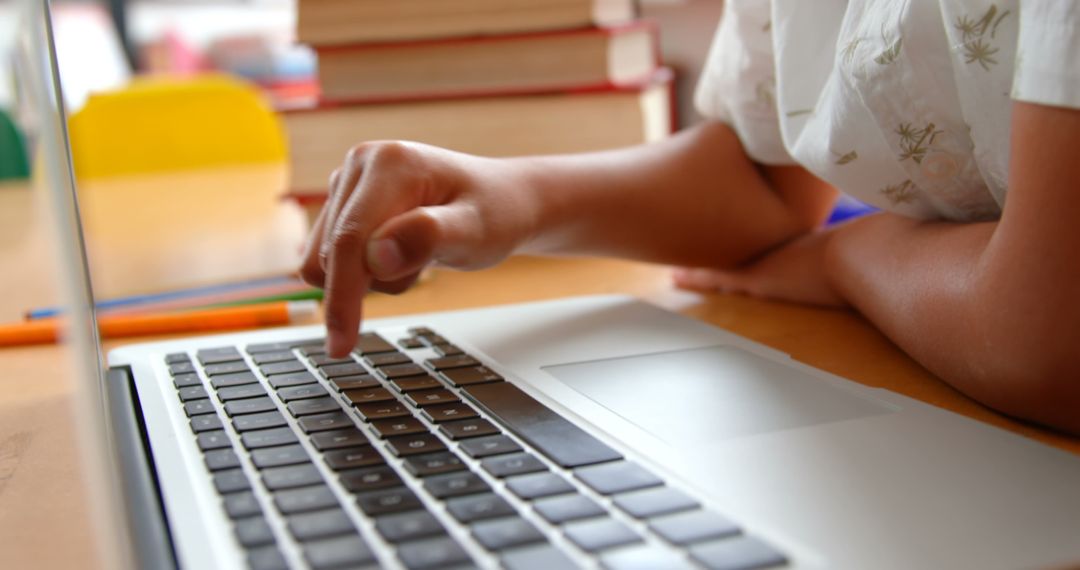 Child Engaged with Online Learning on Laptop in Classroom