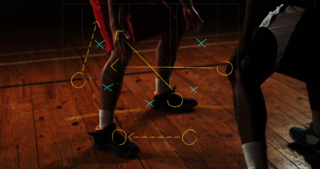 Basketball Players Analyzing Strategy on Court with Diagram