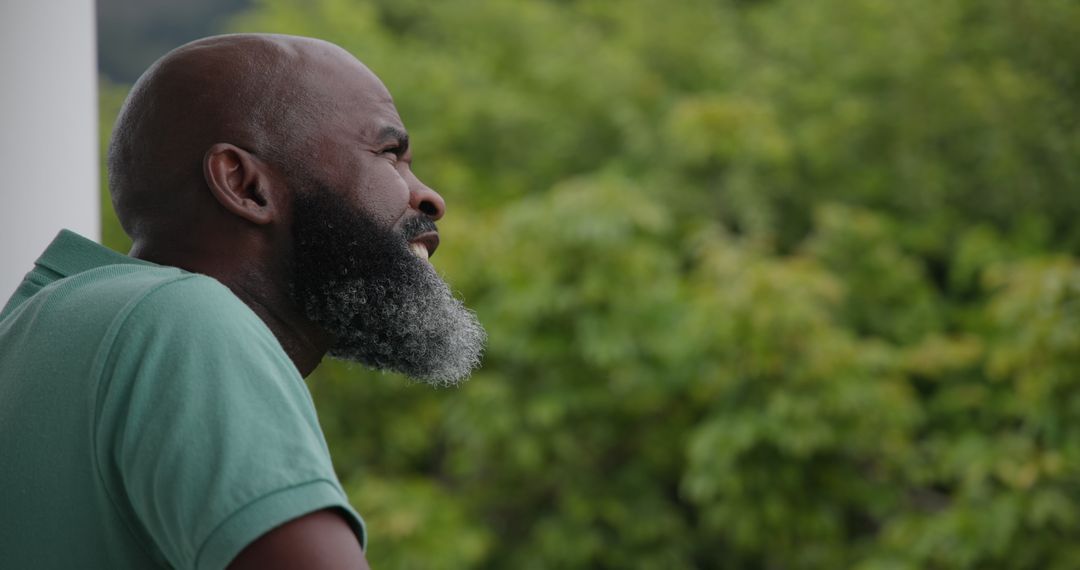 Man with Beard Enjoying Peaceful Outdoor View