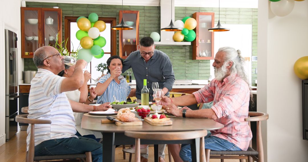 Senior Group Celebrating with Toast at Festive Dinner Gathering