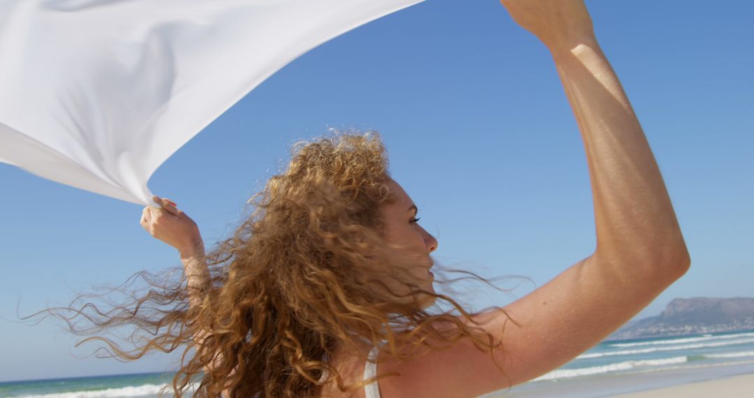 Woman Enjoying Sunny Beach with White Fabric - Free Images, Stock Photos and Pictures on Pikwizard.com