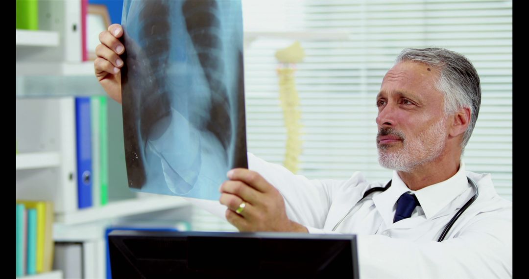 Experienced Doctor Reviewing X-ray in Medical Office - Free Images, Stock Photos and Pictures on Pikwizard.com