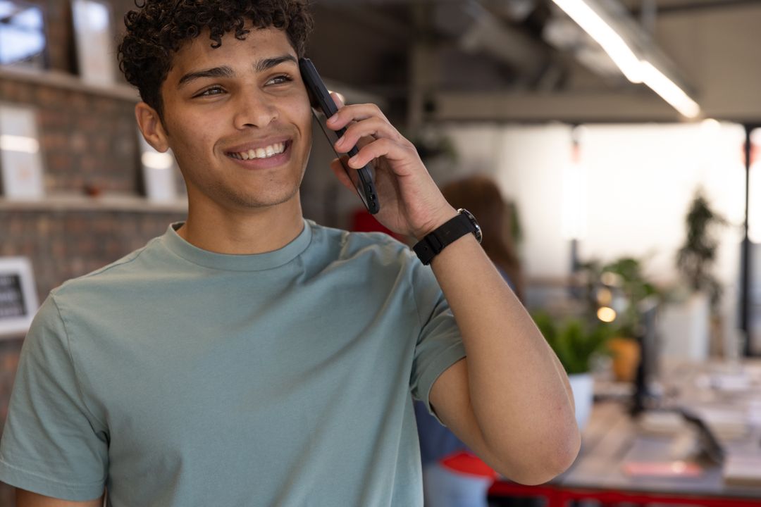 Young Professional Engaged in a Smartphone Call in Modern Office
