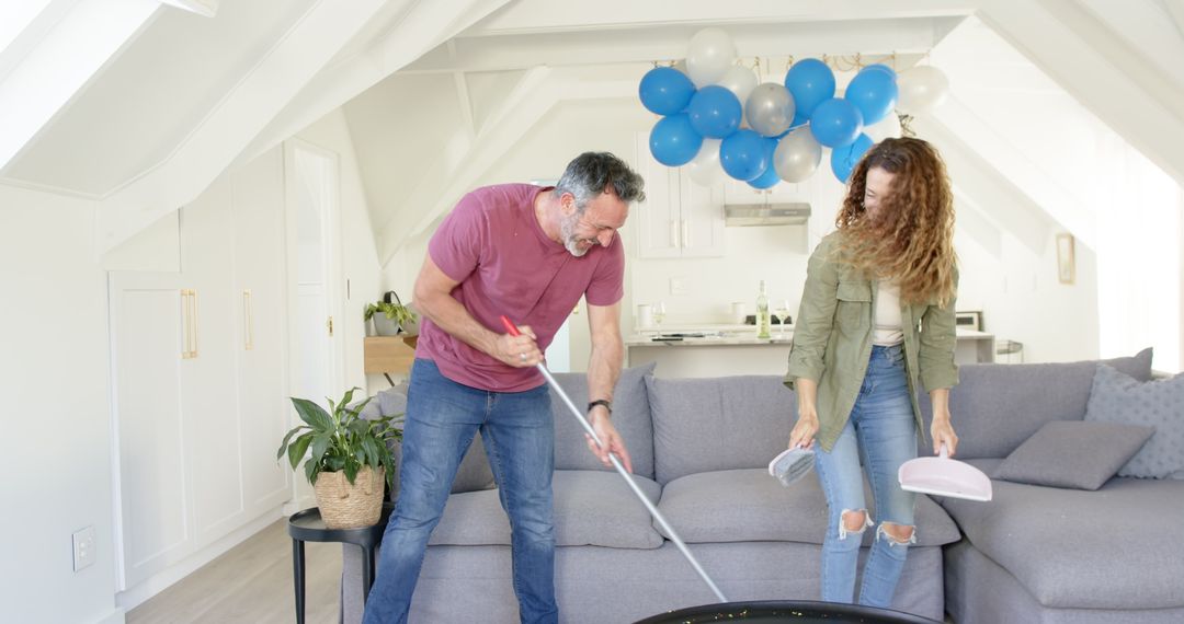 Joyful Mature Couple Teamwork in Living Room Cleaning Amid Celebration