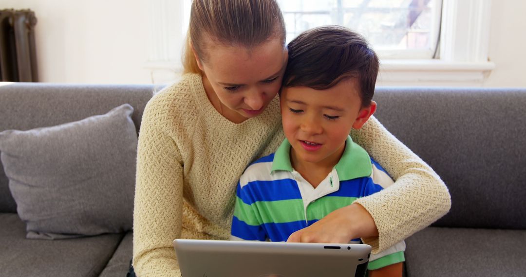 Mother and Son Using Tablet at Home - Free Images, Stock Photos and Pictures on Pikwizard.com