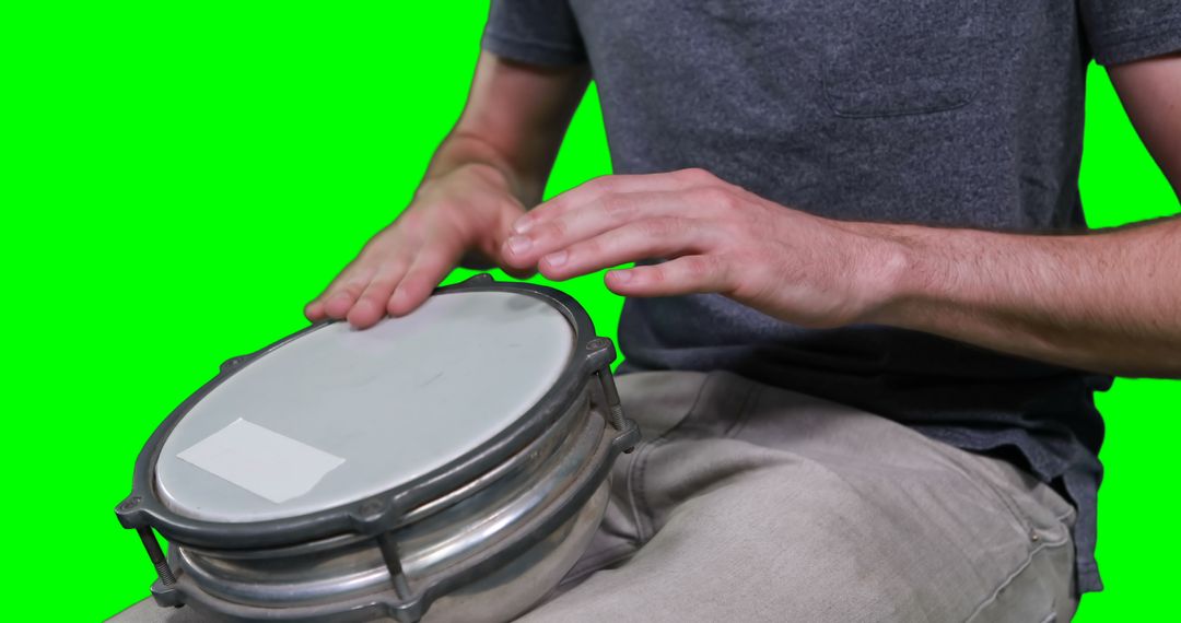 Close-Up of Person Playing Bongo Drums With Isolated Green Background - Free Images, Stock Photos and Pictures on Pikwizard.com