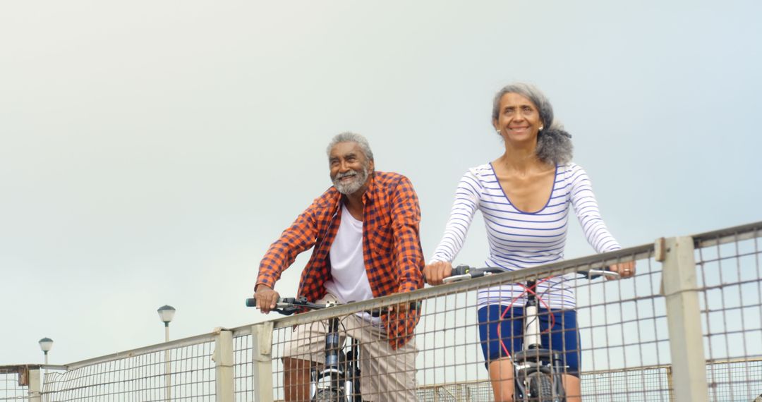 Active Senior Couple Enjoying Bike Ride by the Sea