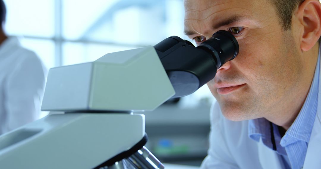 Scientist Examining Samples with Microscope in Laboratory - Free Images, Stock Photos and Pictures on Pikwizard.com