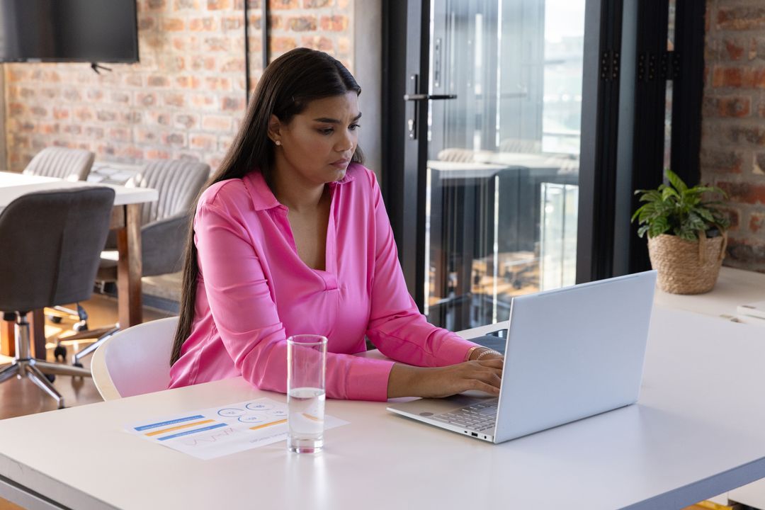Focused Businesswoman Analyzing Data in Modern Office Space