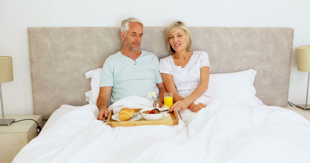 Senior Couple Enjoying Breakfast in Bed, Relaxing Morning Together - Free Images, Stock Photos and Pictures on Pikwizard.com