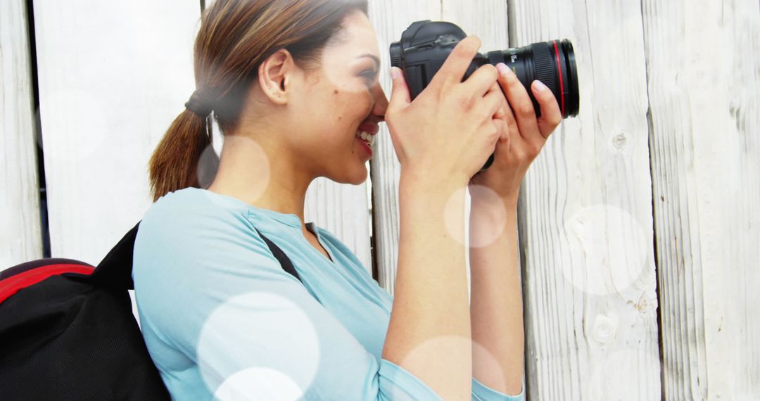 Female Photographer Capturing Photo with DSLR Camera Outdoors