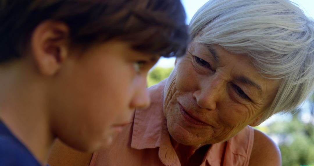 Caring Grandmother Looking at Grandson Outdoors in Park - Free Images, Stock Photos and Pictures on Pikwizard.com