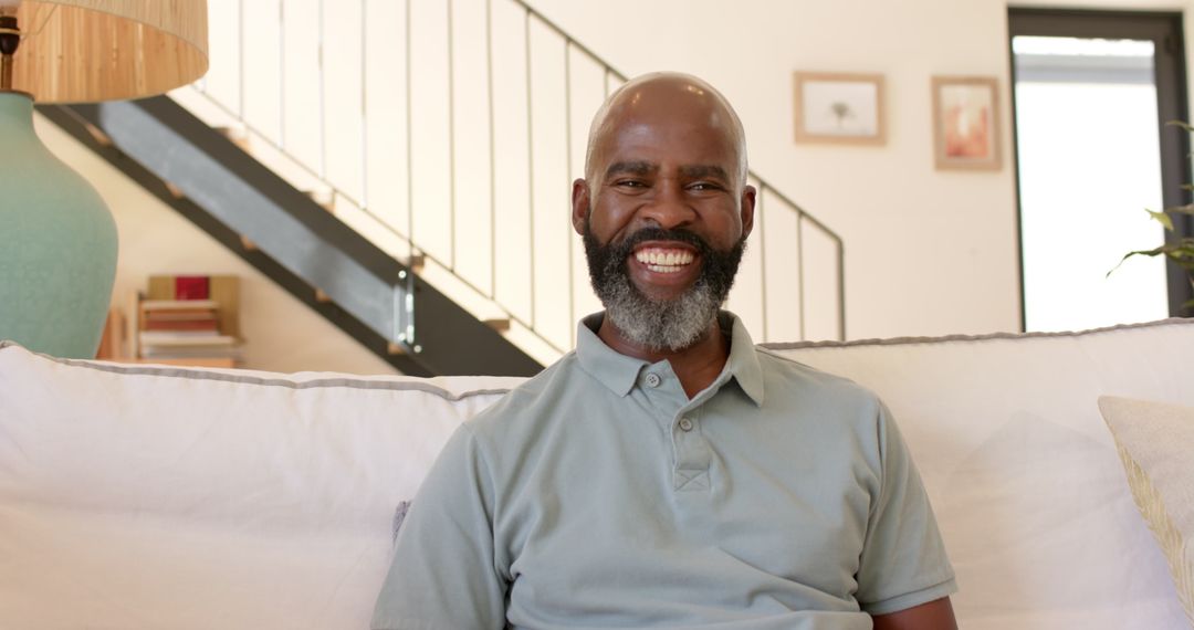 Senior Man Relaxing and Smiling on Couch at Home