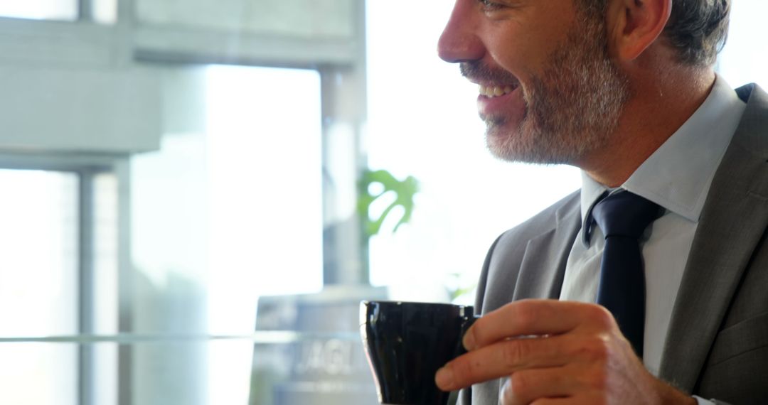 Businessman Enjoying Coffee Break in Office - Free Images, Stock Photos and Pictures on Pikwizard.com