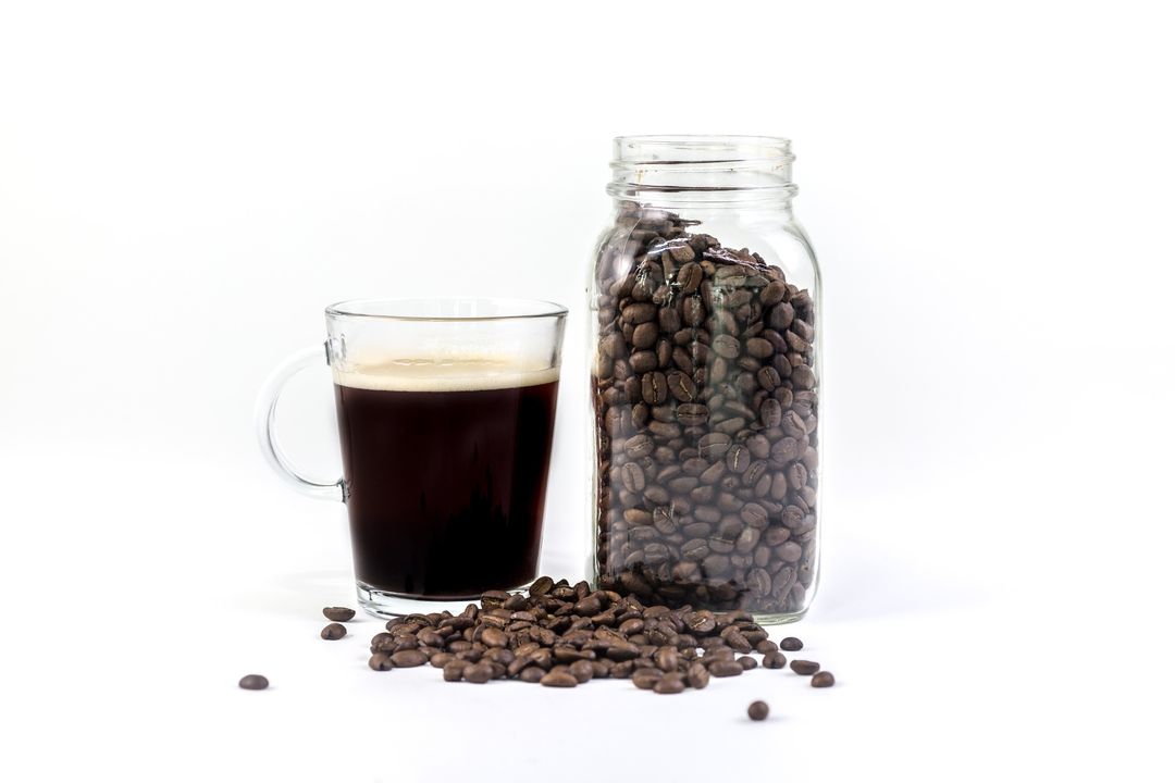 Freshly Brewed Coffee with Beans in Glass Jar on White Background