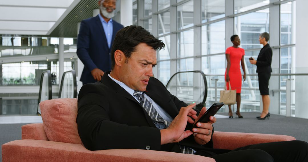 Businessman Using Smartphone at Modern Office Lounge - Free Images, Stock Photos and Pictures on Pikwizard.com