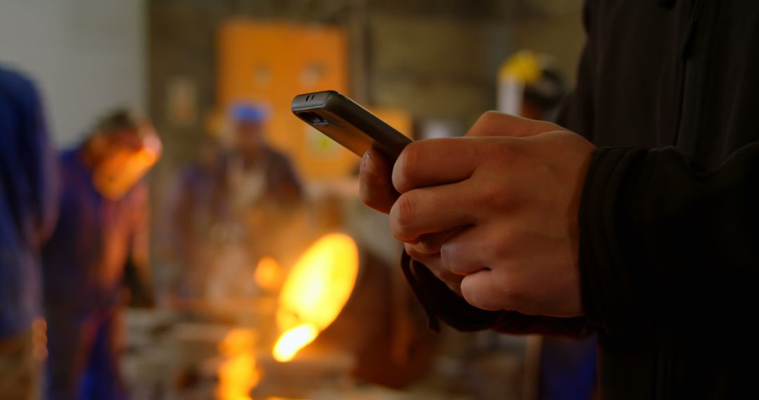 Worker Using Mobile Technology in Industrial Workshop