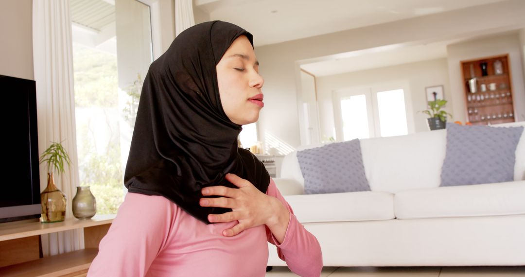 Young Muslim Woman Practicing Mindfulness and Deep Breathing at Home - Free Images, Stock Photos and Pictures on Pikwizard.com