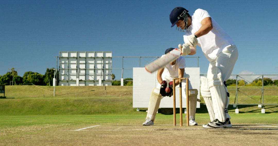 Batsman Playing Defensive Shot During Cricket Match on Sunny Day - Free Images, Stock Photos and Pictures on Pikwizard.com