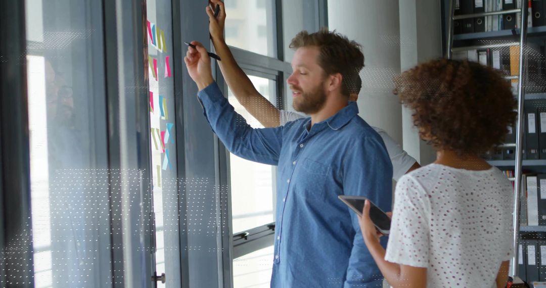 Dedicated Team Collaborating in Modern Office with Sticky Notes