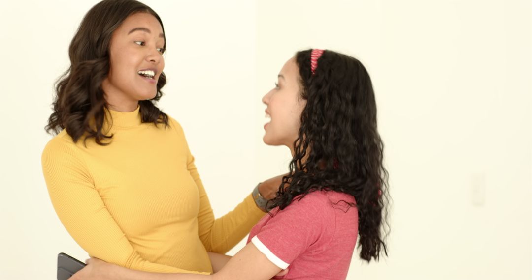 Mother and Daughter Hugging Joyfully at Home