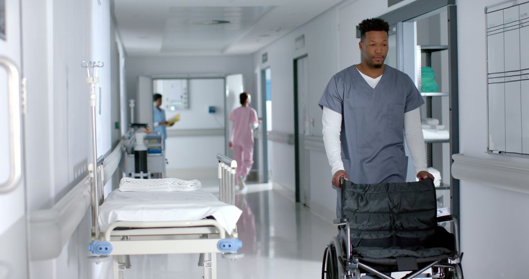 Healthcare Worker Pushing Wheelchair in Modern Hospital Hallway - Free Images, Stock Photos and Pictures on Pikwizard.com