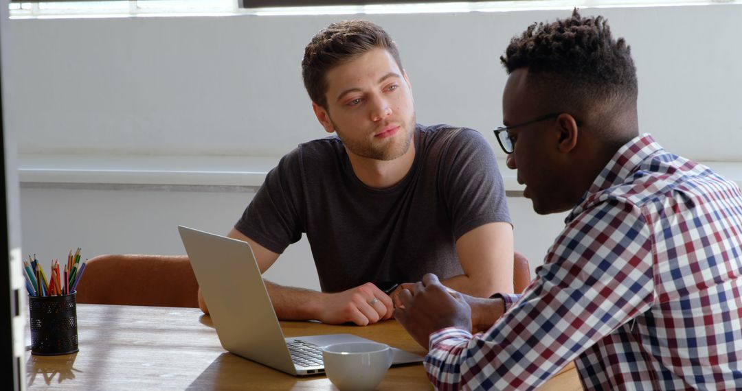 Two Professionals Discussing Ideas in Modern Office Setting