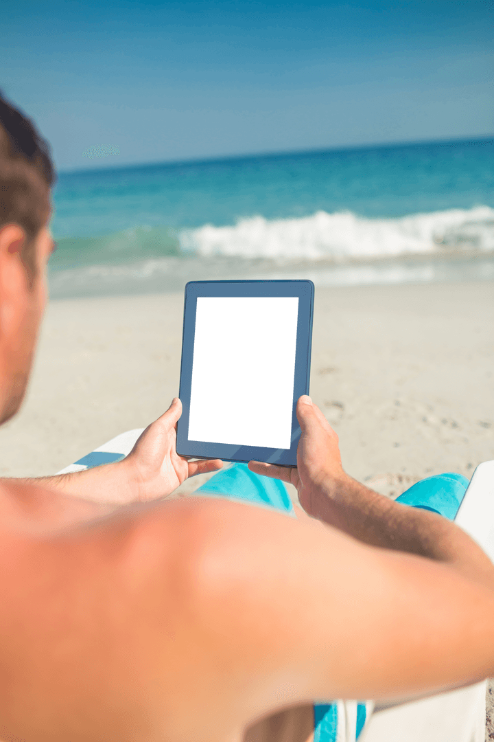 Man Using Tablet with Transparent Screen Relaxing on Beach