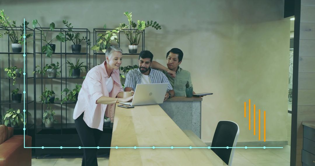 Diverse Team Leaning Over Laptop Planning Modern Workspace