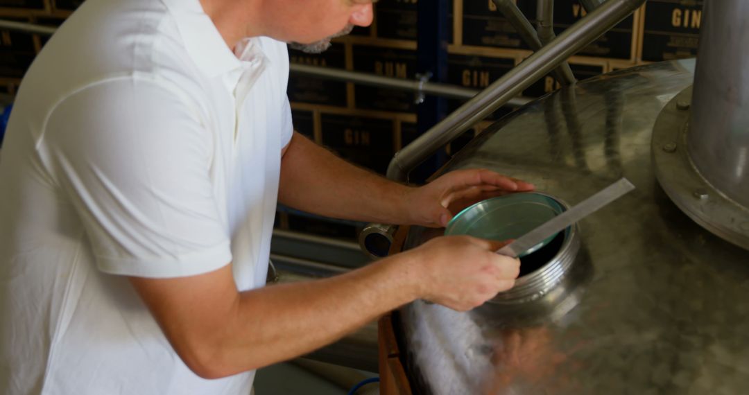 Man Working With Brewery Equipment in Distillery - Free Images, Stock Photos and Pictures on Pikwizard.com