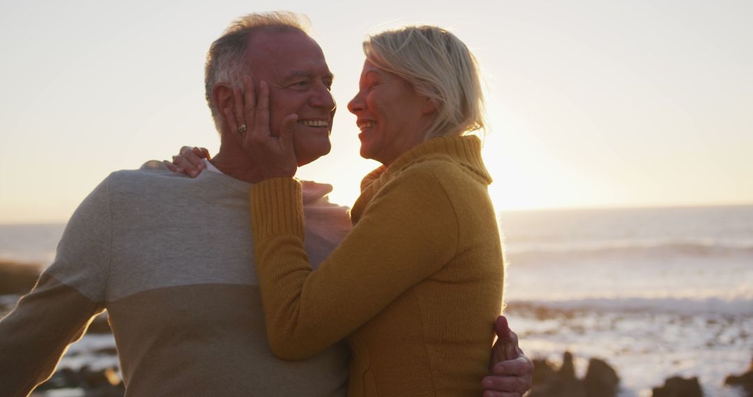 Happy Senior Couple Embracing at Sunset Beach - Free Images, Stock Photos and Pictures on Pikwizard.com