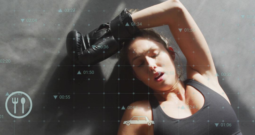 Exhausted athlete resting on gym mat with fitness data overlay and tracking icons