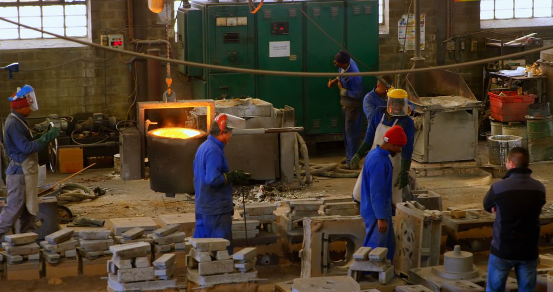 Workers Wearing Protective Gear in Metal Foundry Industry Workshop - Free Images, Stock Photos and Pictures on Pikwizard.com