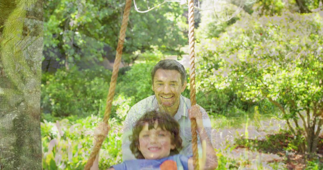 Father Playing with Son on Swing in Sunny Green Park
