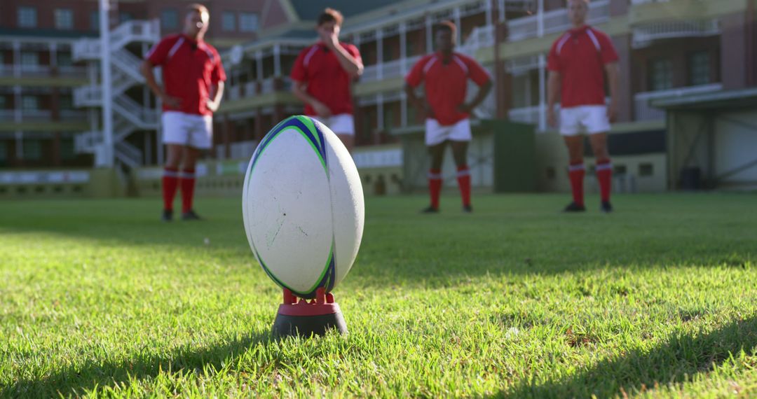 Focused rugby Players Huddling On Field With Close-Up Of Ball On Tee - Free Images, Stock Photos and Pictures on Pikwizard.com