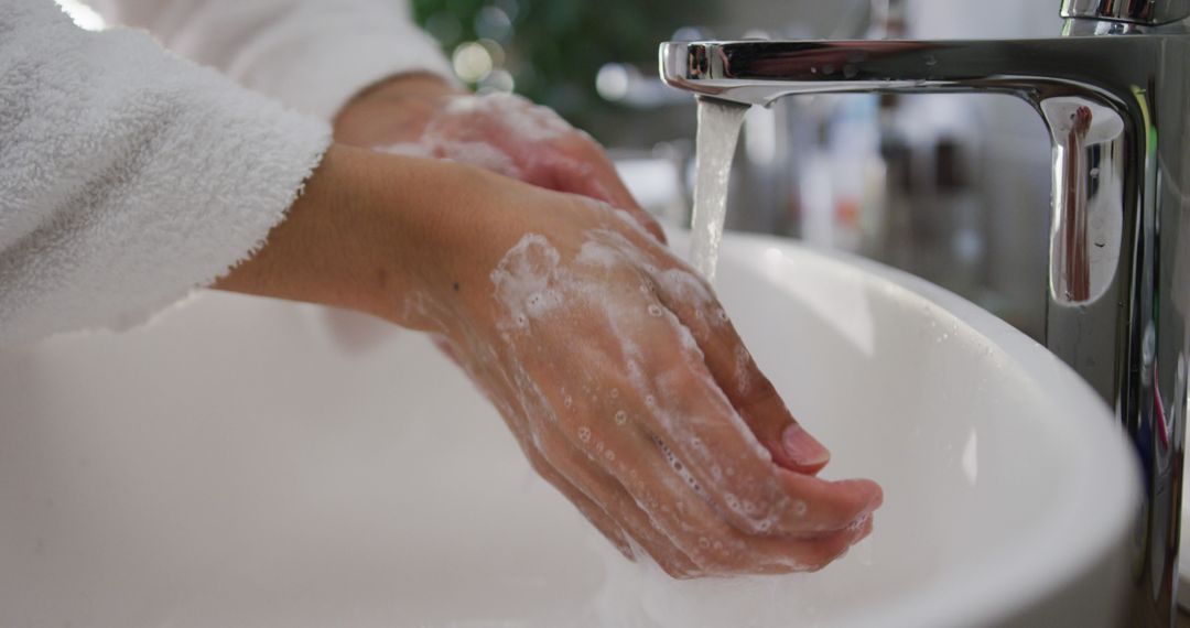 Person Washing Hands with Soap at Sink for Hygiene and Safety - Free Images, Stock Photos and Pictures on Pikwizard.com